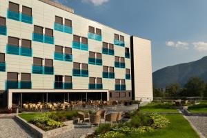 a building with tables and chairs in front of it at Quality Hotel Sogndal in Sogndal