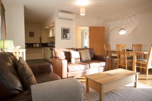 a living room with a couch and a table at Loch Ness Abbey Cottages in Fort Augustus