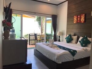 a bedroom with two beds and a balcony at KK Lipe Resort in Ko Lipe