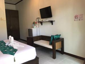 a room with two beds and a tv on the wall at KK Lipe Resort in Ko Lipe +47 photos