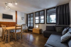 a living room with a couch and a table at Apartment Jonquille 3 in Chamonix
