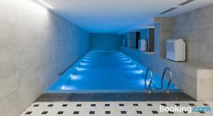a swimming pool with blue lighting in a bathroom at Parliament on Rustaveli Studio in Tbilisi City