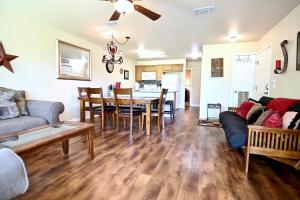 a living room with a couch and a table and chairs at Guadalupe Getaway in New Braunfels