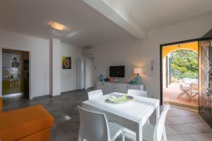 a living room with a white table and chairs at La Sterlizia di Santa Croce in Alassio