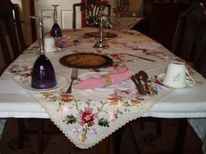 a table with a table cloth with flowers on it at Barn-Gill House in Thirlmere