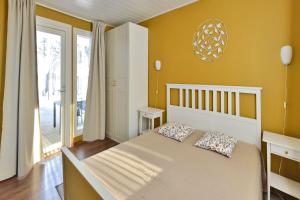 a bedroom with a large bed and a large window at ONNI Village in Ruokolahti