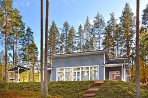 a house in the woods with trees at ONNI Village in Ruokolahti