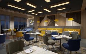 a restaurant with tables and chairs and yellow and blue chairs at Holiday Inn Express Chengdu Jinniu, an IHG Hotel in Chengdu
