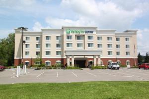 a hotel with a parking lot in front of it at Holiday Inn Express - Cortland, an IHG Hotel in Cortland