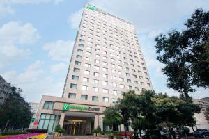 a tall white building with a sign on it at Holiday Inn Express Gulou Chengdu, an IHG Hotel in Chengdu