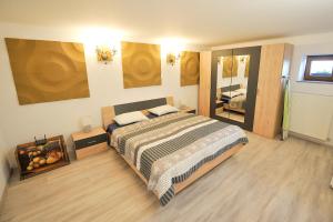 a bedroom with a large bed and a large mirror at Apartments Jernej with Onsite Wellness in Brežice
