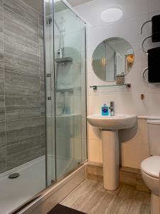 a bathroom with a sink and a shower at Serviced Apartment Bristol One-Bedroom Southmead Hospital MOD Airbus in Bristol
