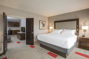 a hotel room with a bed and a dresser at Holiday Inn Hotel & Suites Cincinnati Downtown, an IHG Hotel in Cincinnati