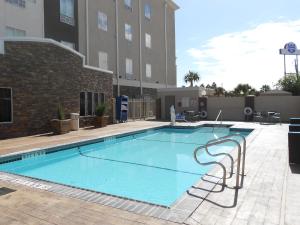 a large swimming pool in front of a building at Holiday Inn Express & Suites Corpus Christi - North, an IHG Hotel in Corpus Christi