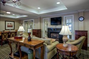 a living room with a couch and a fireplace at Holiday Inn Express Hotel & Suites Jackson - Flowood, an IHG Hotel in Flowood