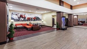 a lobby of a hotel with red couches and chairs at Holiday Inn Express Hotel and Suites Duncan, an IHG Hotel in Duncan