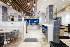 a view of the dining area of a restaurant with tables and chairs at Holiday Inn Express Dublin City Centre, an IHG Hotel in Dublin