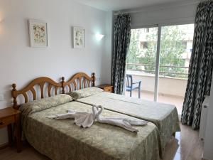 a bedroom with a bed with a dress on it at Edificio C'an Patilla in Cala Ratjada