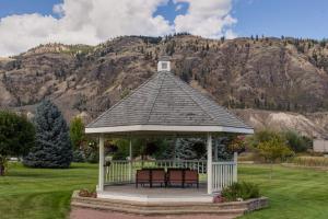 a gazebo in a field with a mountain at South Thompson Inn & Conference Centre in Kamloops