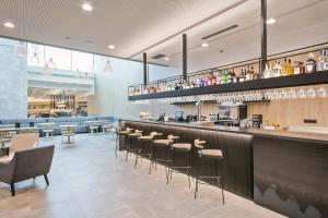 a restaurant with a bar with stools at Acta Voraport in Barcelona