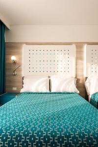 Una cama o camas en una habitación de Hotel Casa Blanca