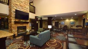 a hotel lobby with a fireplace and a tv at Staybridge Suites - Cincinnati North, an IHG Hotel in West Chester