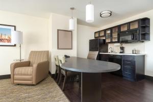 a kitchen and living room with a table and chairs at Candlewood Suites Columbia Hwy 63 & I-70 by IHG in Columbia