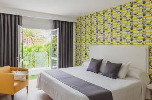 a bedroom with a bed and a yellow wall at Flamingo Beach Mate in Adeje