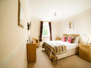 Schlafzimmer mit einem Bett und einem Fenster in der Unterkunft OYO White Horse Lodge Hotel, East Thirsk in Thirsk