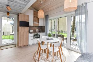 a kitchen and dining room with a table and chairs at Stunning Seaside Haus in Palanga