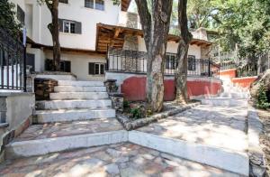 a house with stairs and trees in front of it at Dal Centurione in Rome
