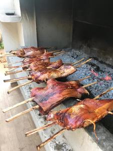 a group of chickens and meat on a grill at Hotel Barbagia in Dorgali