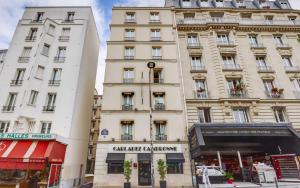 two tall white buildings on a city street at Carladez Cambronne in Paris