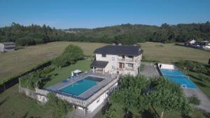 an aerial view of a house with a swimming pool at A Quinta de Lapido in Ortoño