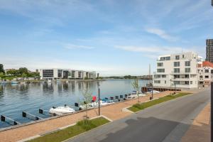 a marina with boats in the water next to a building at Harbour Penthouse in Sønderborg
