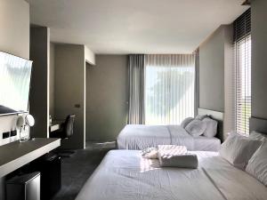 Postel nebo postele na pokoji v ubytování Doowall Hotel