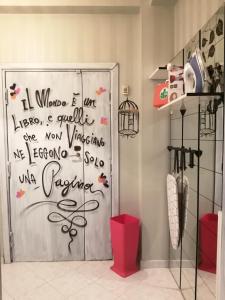 a bathroom with a door with writing on it at B&B A Casa Dei Nonni in Capua