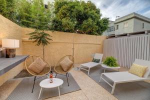 a patio with two chairs and a swing at Le Palmette Suites in Cagliari