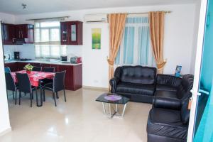 a kitchen and a living room with a table and chairs at Residence Coin De Mire in Bain Boeuf