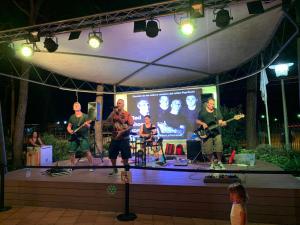 a group of men playing music on a stage at Camping Bella Terra in Blanes