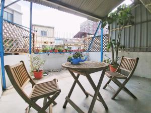 a table and two chairs on a balcony at Gred House B&B in Guiren