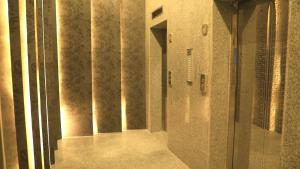 a hallway of a building with concrete walls and columns at كريستال الخليج للشقق الفندقيه in Kuwait +56 photos