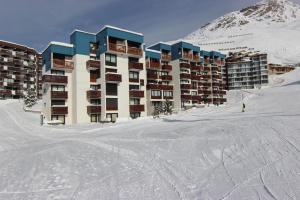 a building on a ski slope in the snow at L'olympic in Val Thorens