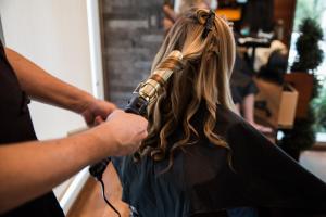 a woman getting her hair styled at a salon at Naples Grande Beach Resort in Naples