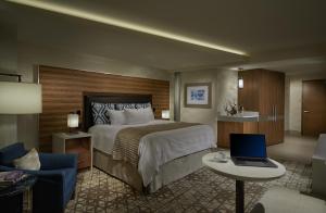 a hotel room with a bed and a laptop on a table at Seminole Hard Rock Hotel and Casino Tampa in Tampa