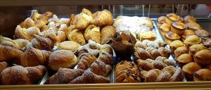 a display case in a bakery filled with lots of pastries at Le Volte in Sannicola