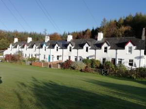 a large white building with a row of houses at Crinan Canal Cottage No8 in Lochgilphead