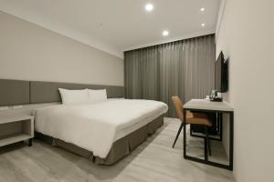 Voodi või voodid majutusasutuse Fengjia JinRui Hotel toas