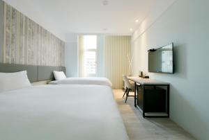 Postel nebo postele na pokoji v ubytování Fengjia JinRui Hotel