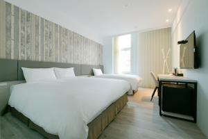 Voodi või voodid majutusasutuse Fengjia JinRui Hotel toas